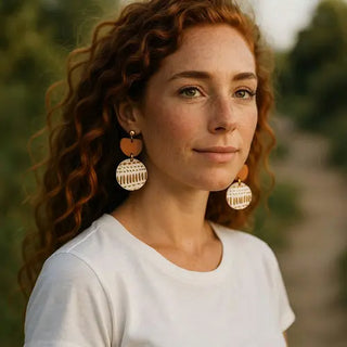Woman wearing large earrings with a blurred natural background