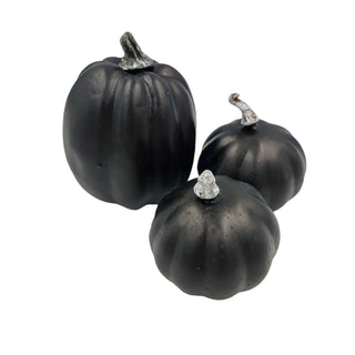 Three black decorative pumpkins with silver stems on a white background