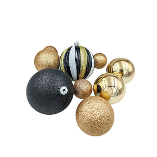 Decorative Christmas ornaments in gold, black, and silver on a white background