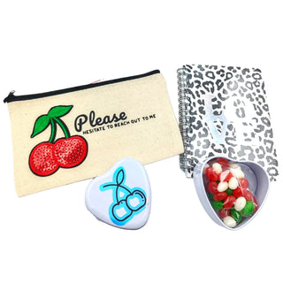 Cherry on Top gift bundle with cherry-themed accessories and gourmet snacks on a white background