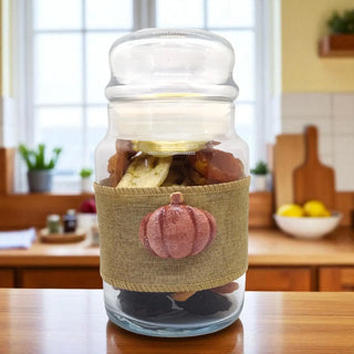 Glass jar with a decorative pumpkin label on a kitchen counter