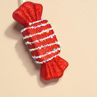 Confetti nougat candy ornament on frosted pine tree with warm fairy lights. red and white Candyland Christmas decorating inspiration