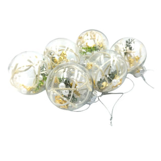 Clear balloons with gold confetti and greenery on a white background