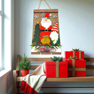 Decorative Christmas sign with Santa and gnome on a wooden bench with red gifts.
