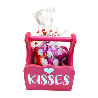 Pink container with chocolates and the word kiss