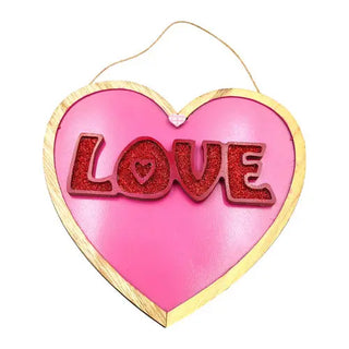 Pink wooden heart with the word love in red glitter valentines day decor