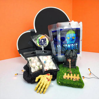 Ghoulishly themed items including a zombie hand, candy, and decorative elements on an orange background.