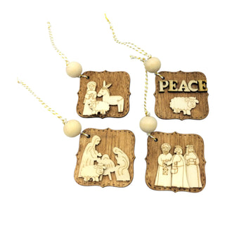 Wooden nativity scene necklace with 'PEACE' pendant on a white background