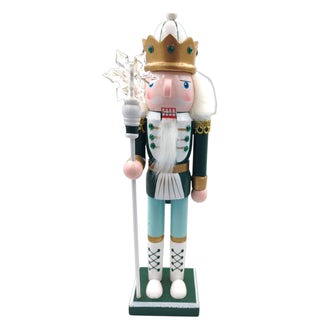 Decorative nutcracker figure with a crown and staff on a white background for a sage Christmas aesthetic