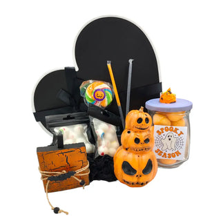 black heart shaped box. orange ceramic pumpkin stack, wooden pumpkin, lollipop, 2 candy eye packets, 2 halloween themed candy straws and a Halloween themed jar filled with candy