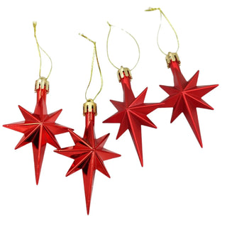 Red star-shaped Christmas ornaments with gold bases on a white background