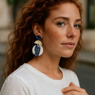 Woman wearing large earrings with a blurred background