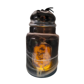 Halloween-themed bottle with spider web and spider decoration on a white background