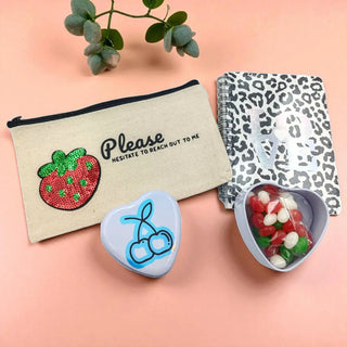 Berry-themed gift set with pink and purple packaging, ideal for fruity gift lovers on a peach background