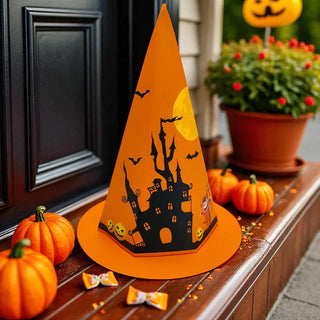 Halloween-themed decoration with an orange hat featuring a haunted house design on a wooden surface.