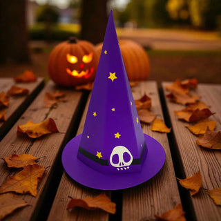 Purple witch hat with skull design on a wooden surface with pumpkins in the background