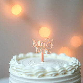 Elegant Mr and Mrs cake topper in wood finish with heart design on a white cake