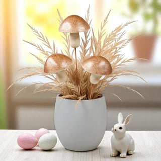 Decorative arrangement with a pot of plants, mushrooms, and a small rabbit figurine on a table.