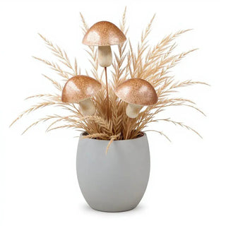 Decorative arrangement with mushrooms and dried grasses in a gray pot on a white background
