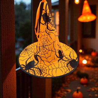Halloween-themed decorative light with spiders and cobwebs on a blurred background