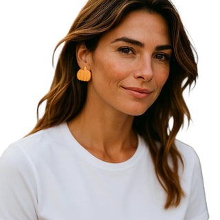 Woman wearing yellow earrings on a white background