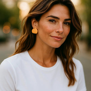 Woman wearing yellow earrings with a blurred background