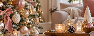Christmas decorations in pink, gold and white with a decorated tree, baubles and festive table decor