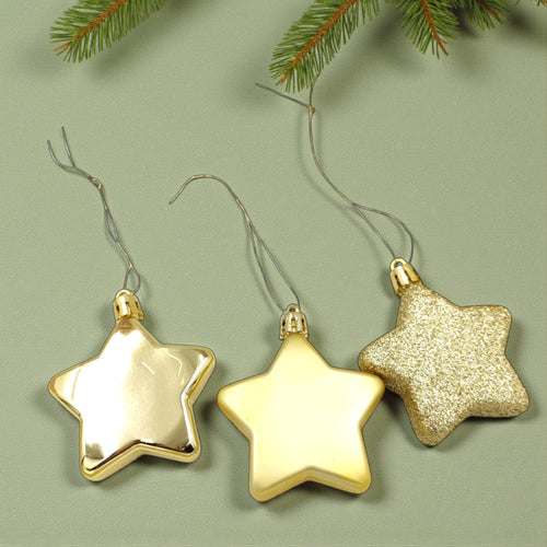 Three gold star-shaped ornaments on a green background with pine branches.