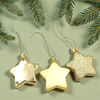 Three gold star-shaped Christmas ornaments on a light green background with pine branches.