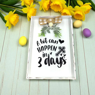 Decorative sign with Easter message and flowers on a light wooden background