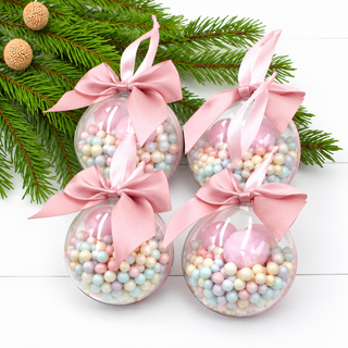 Set of 4 Candyland Christmas baubles – clear 8cm baubles filled with pastel beads and pink satin bows, styled with pine branches – The Holiday Shop