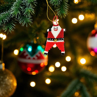 Pixelated Santa Claus ornament hanging on a Christmas tree with blurred lights in the background