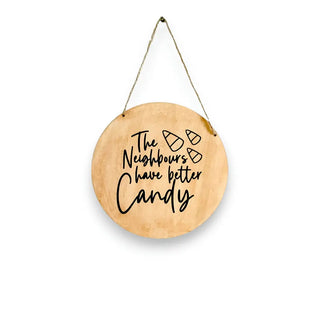 Wooden sign with text hanging on a door, with white background.