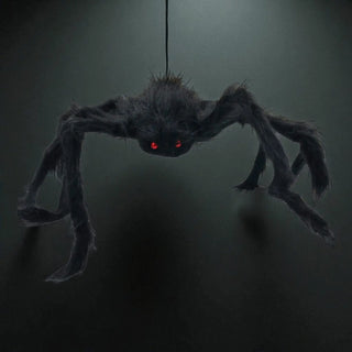 Hanging spider-like creature with red eyes on a dark background