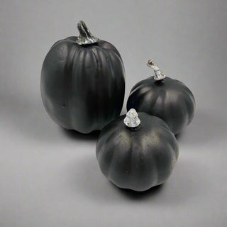 3 Black Pumpkins on a Halloween themed background