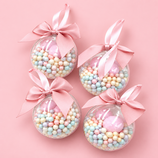 Candyland Christmas Ornament set of 4 – pastel bead-filled clear baubles with pink bows on a pink background