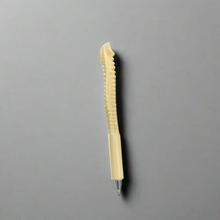 Beige pen on a white surface
