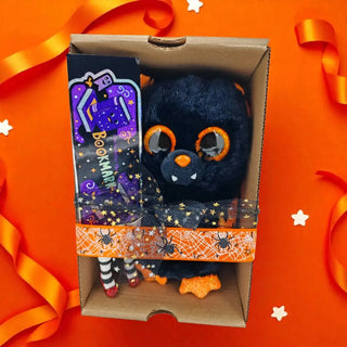 Halloween gift set with bat plush and witchy BOOKmark on orange backdrop