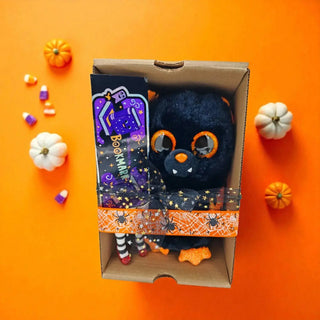 Halloween gift set with bat plush and witchy BOOKmark on orange backdrop