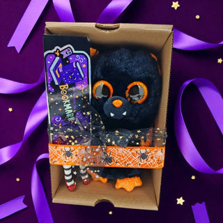 Halloween gift set with bat plush and witchy BOOKmark on purple backdrop