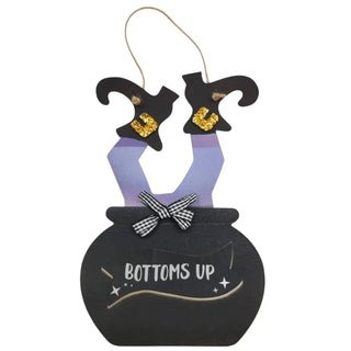 Hanging decoration with witch legs and a pot labeled 'Bottoms Up' on a white background