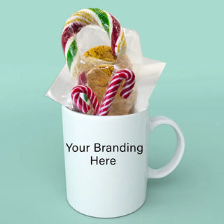 white mug with christmas cookies and candy on a turqouise background