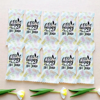 Packaging with 'no bunny loves me like Jesus' text on a light background with floral designs.