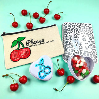 Cherry on Top gift bundle with cherry-themed accessories and gourmet snacks on a white background