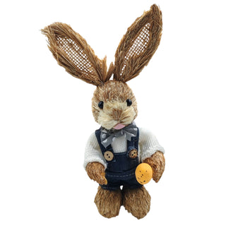 Plush toy rabbit with straw-like ears and overalls on a white background