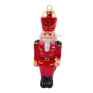 Red nutcracker Christmas ornament on a white background