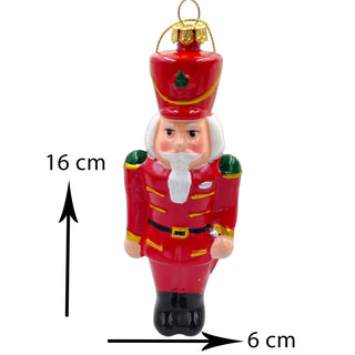 Red nutcracker Christmas ornament with measurements on a white background