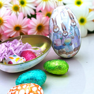 Easter-themed foil wrapped eggs with a decorative egg and flowers in the background.