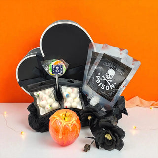 Halloween-themed candy set with 'poison' label and apple on an orange background