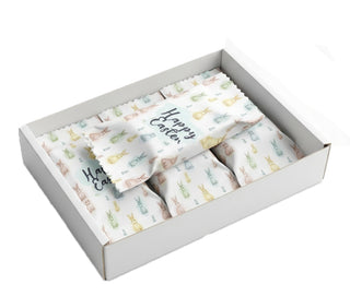 Box of eggs with Easter-themed designs on a white background